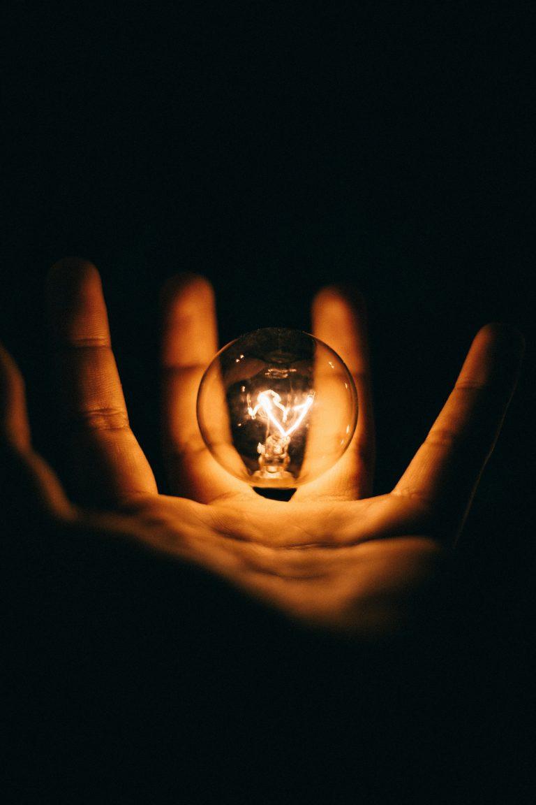 hand holding lightbulb